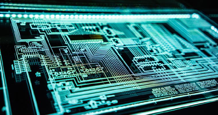 Circuit board glowing under a blacklight